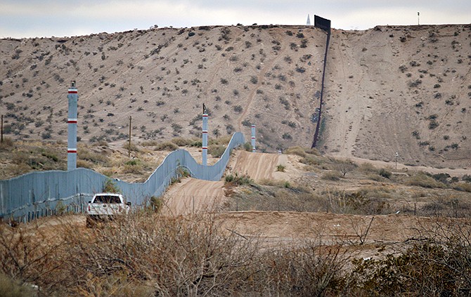 A U.S. Border Patrol agent drives near the U.S.-Mexico border fence in Sunland Park, New Mexico. A new Cronkite News-Univision News-Dallas Morning News Border Poll released Monday says a majority of residents surveyed on both sides of the U.S.-Mexico border are against the building of a wall between the two countries. The poll also suggests residents feel Democrats and Republicans are ignoring their concerns and aren't proposing solutions to help the economy and combat human and drug trafficking.