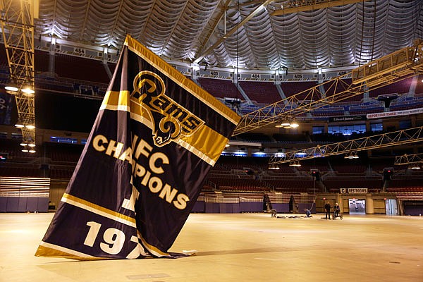 In this Jan. 14, 2016, file photo, championship banners are removed from the ceiling of the Edward Jones Dome, former home of the St. Louis Rams football team, in St. Louis.