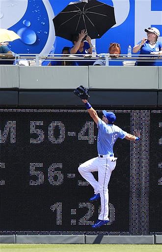 Kansas City Royals right fielder Paulo Orlando goes to the wall after the home run ball hit by Cleveland Indians second baseman Jason Kipnis during the first inning of a baseball game at Kauffman Stadium in Kansas City, Mo., Wednesday, July 20, 2016. 