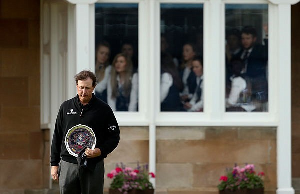 Phil Mickelson looks down as he holds the silver plate, the runner-up trophy, at the British Open Golf Championships on Sunday at the Royal Troon Golf Club in Troon, Scotland.