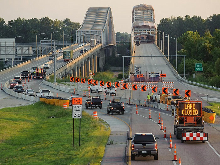 Westbound traffic funnels down to a single lane before crossing the U.S. 54/63 Missouri River Bridge as MoDOT crews get set to perform maintenance on Wednesday evening. MoDOT officials predicted both westbound lanes into Jefferson City would be open before rush hour Thursday morning.