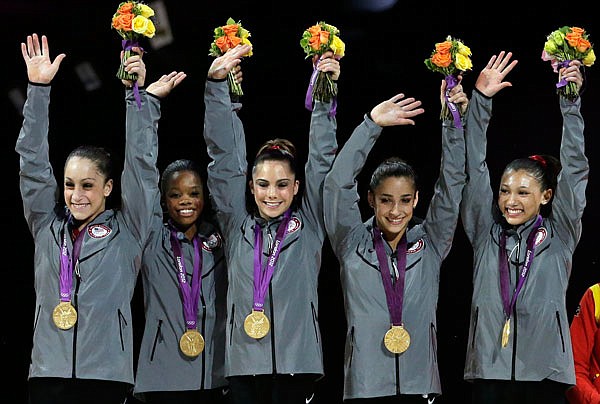 In this July 31, 2012, file photo, U.S. gold medal gymnasts Jordyn Wieber, Gabrielle Douglas, McKayla Maroney, Alexandra Raisman and Kyla Ross raise their hands on the podium during the medal ceremony for the Artistic Gymnastic women's team final at the 2012 Summer Olympics in London.