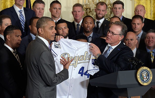 President Barack Obama holds up a personalized Royals jersey presented to him by team manager Ned Yost during a ceremony Thursday in the East Room of the White House in Washington.