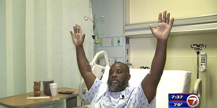 In this Wednesday frame from video, Charles Kinsey explains in an interview from his hospital bed in Miami what happened when he was shot by police on Monday. Kinsey, a therapist who was trying to calm an autistic patient in the middle of the street, said he was shot even though he had his hands in the air and repeatedly told the police no one was armed. 