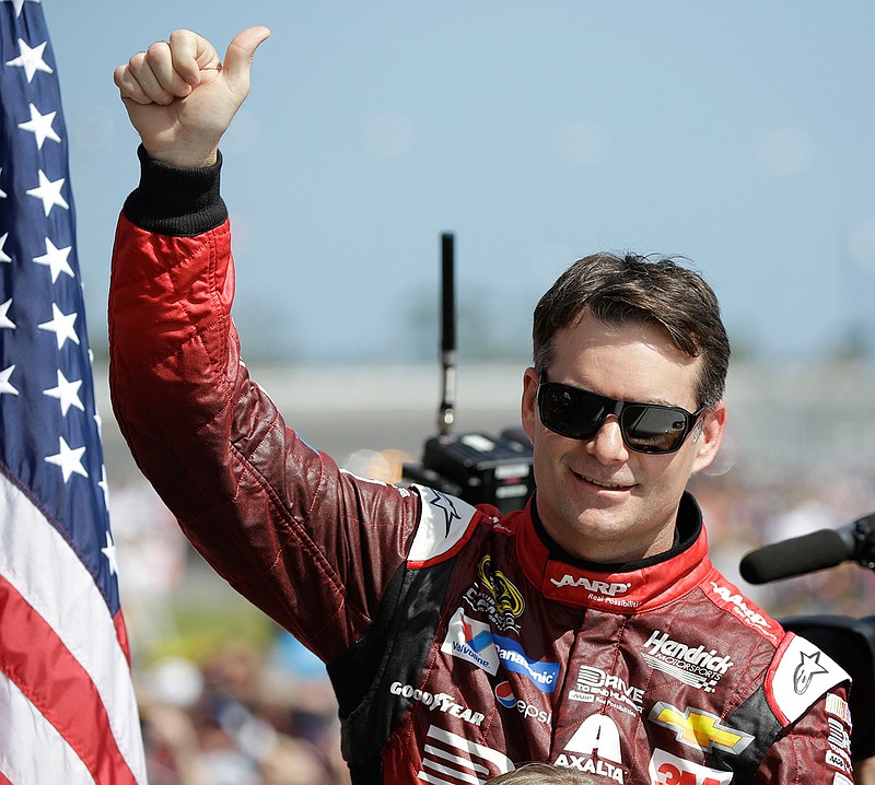 In this Feb. 22, 2015, file photo, Jeff Gordon gives a thumbs-up to the crowd as he in introduced before the Daytona 500 NASCAR Sprint Cup series auto race at Daytona International Speedway in Daytona Beach, Fla. Dale Earnhardt Jr. will miss two more races as he recovers from concussion-like symptoms and retired NASCAR champion Jeff Gordon will replace him at Indianapolis and Pocono. The announcement came Wednesday, July 20, 2016,  from Hendrick Motorsports, which said Earnhardt has not been cleared by doctors to drive. 