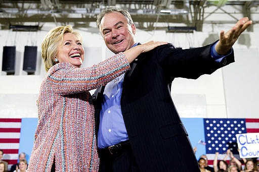 In this July 14, 2016, file photo, Democratic presidential candidate Hillary Clinton, accompanied by Sen. Tim Kaine, D-Va., speaks at a rally at Northern Virginia Community College in Annandale, Va. Clinton has chosen Kaine to be her running mate.