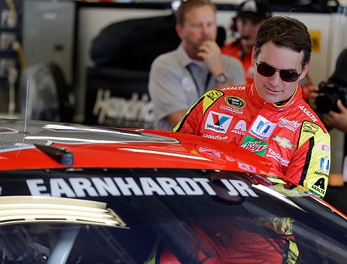 Jeff Gordon climbs into the car during practice Friday for the Brickyard 400 at the Indianapolis Motor Speedway in Indianapolis.