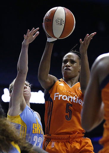 Connecticut Sun guard Jasmine Thomas (5) goes up with the ball next to Chicago Sky guard Courtney Vandersloot (22) during the first half of a WNBA basketball game Friday, July 22, 2016, in Rosemont, Ill.