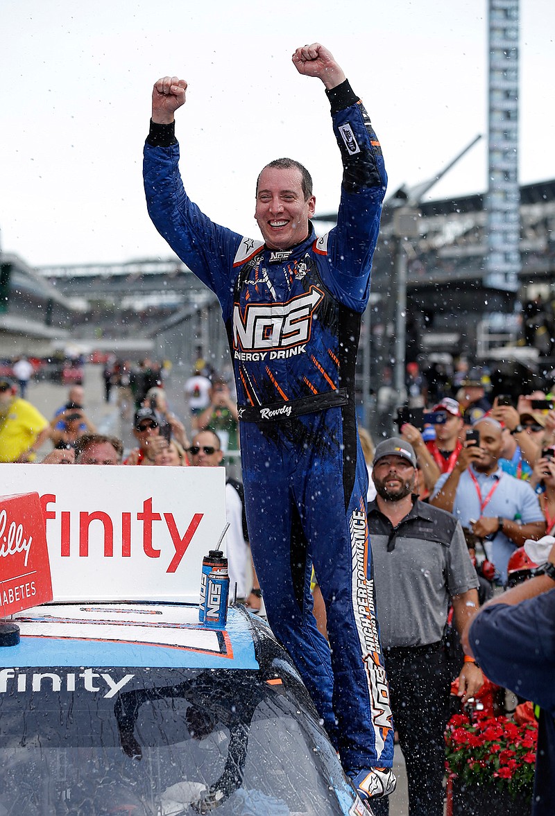 Kyle Busch celebrates after winning the NASCAR Xfinity Series auto race at Indianapolis Motor Speedway in Indianapolis, Saturday, July 23, 2016. 
