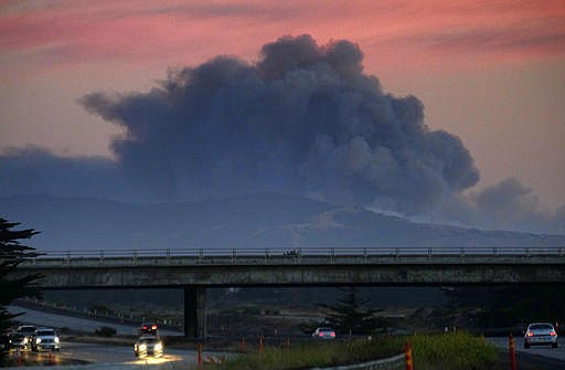 A large plume of smoke from a wildfire rises near Highway 1, burning five miles south of Carmel, Calif., on Friday, July 22, 2016.