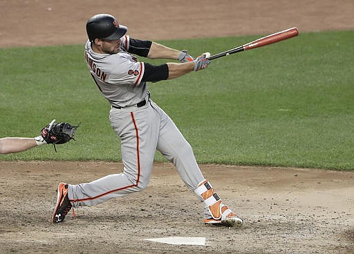 San Francisco Giants' Mac Williamson connects for an RBI-base hit against the New York Yankees during the twelfth inning of a baseball game, Saturday, July 23, 2016, in New York. Giants' Trevor Brown scored on the play.