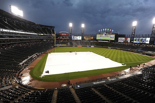 A tarp covers the field during a rain delay that started at the end of the second inning of a baseball game between the Chicago White Sox and the Detroit Tigers at U.S. Cellular Field, Saturday, July 23, 2016, in Chicago. 