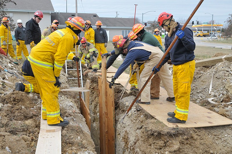 In this Nov. 21, 2014 file photo, several members of the Jefferson City Fire Department participate in trench collapse training. Restoring two firefighter positions lost in 2013 budget cuts are part of Mayor Carrie Tergin's proposed 2016 budget.