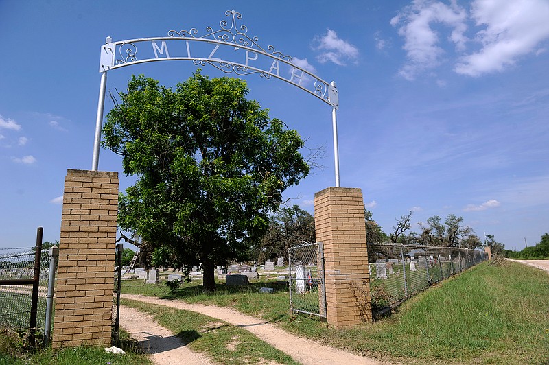 This June 8, 2016 photo, shows the entrance to Pendergrass Cemetery in Sidney, Texas. Texas. The graveyard was struck by a tornado May 26, toppling trees and markers alike.