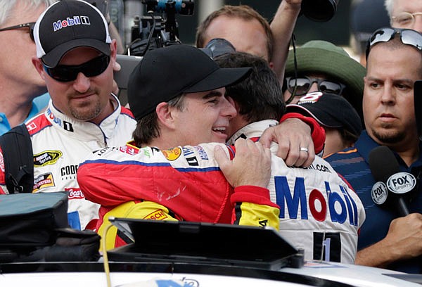 Jeff Gordon and Tony Stewart embrace Sunday following the Brickyard 400 at Indianapolis Motor Speedway in Indianapolis.