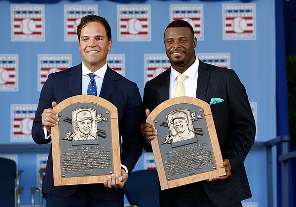 Mike Piazza and Ken Griffey Jr. hold their plaques after Sunday's induction ceremony for the National Baseball Hall of Fame in Cooperstown, N.Y.