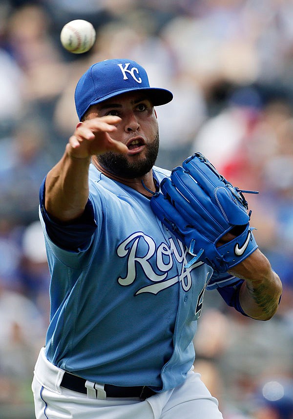 Royals relief pitcher Kelvin Herrera throws to first base for an out during the eighth inning of Sunday afternoon's game against the Rangers at Kauffman Stadium.