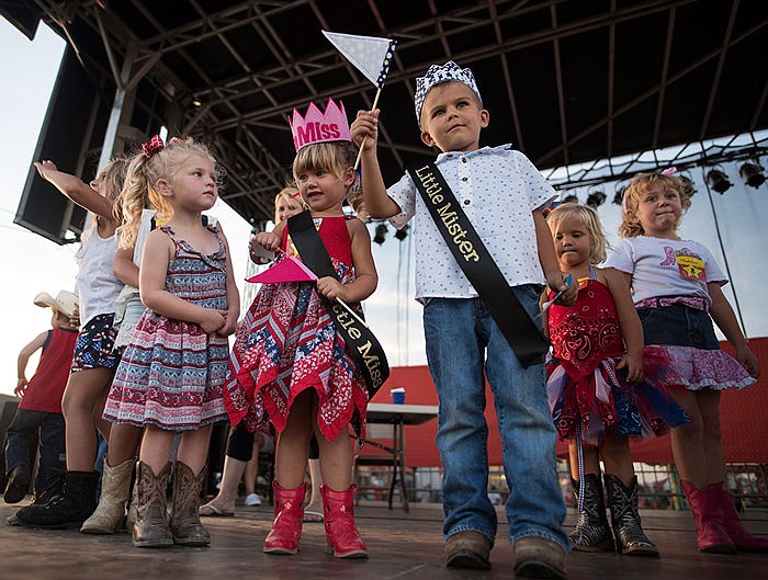 Sophia Hoerschgen, right, and Anson Elder smile and wave at the cheering crowd after being crowned Little Mr. and Miss 2016 at the Jefferson City Jaycees Cole County Fair .
