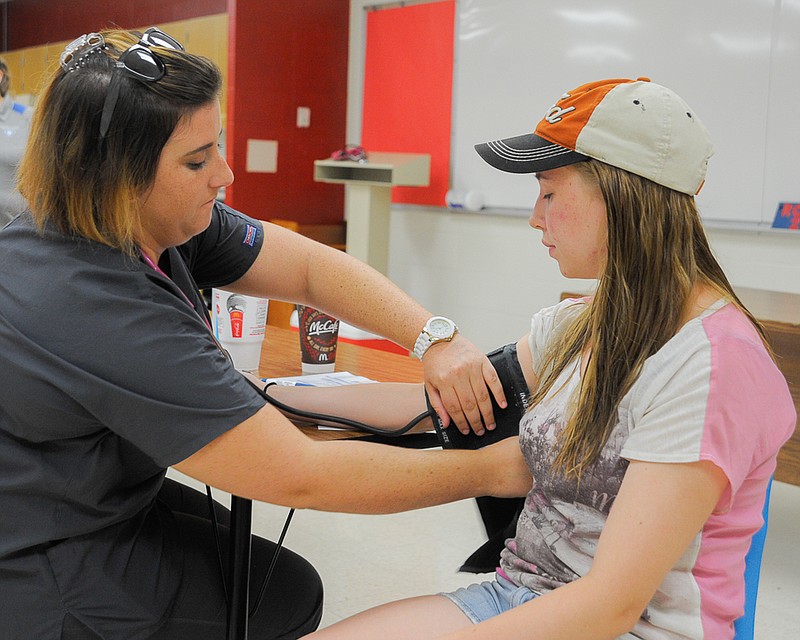 Health screenings and review of immunizations are part of the Moniteau County Back-to-School Fair, where Ashlee Thomas, 15, had her blood pressure checked by Megan Cockrum, a nursing student at Lincoln University.