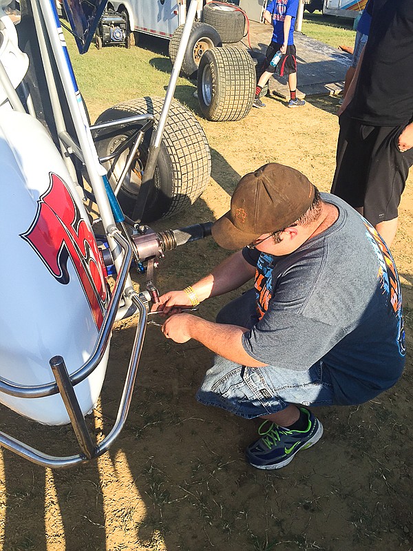 David Burlingame works on Tyler Blank's winged sprint car Sunday at Double-X Speedway.