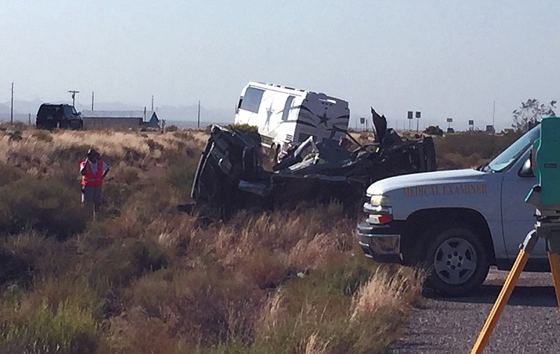 The scene of a bus crash is surveyed Sunday on a highway in northwestern Arizona, about 30 miles north of Kingman. A Dallas Cowboys bus collided with another vehicle and authorities say at least one person was killed. Team spokesman Rich Dalrymple confirmed a Cowboys bus was one of two vehicles involved in the crash Sunday on U.S. 93. 