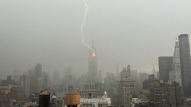 Lightning strikes the Empire State Building on Monday during a storm in New York. Henrik Moltke said he saw the storm approaching from his office window and captured the strike by balancing his phone against the glass. 