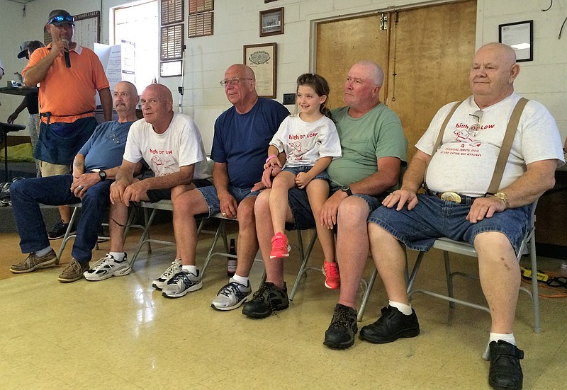 Five men shaved their heads to help raise funds for Addison Hartman's (middle) new service dog.