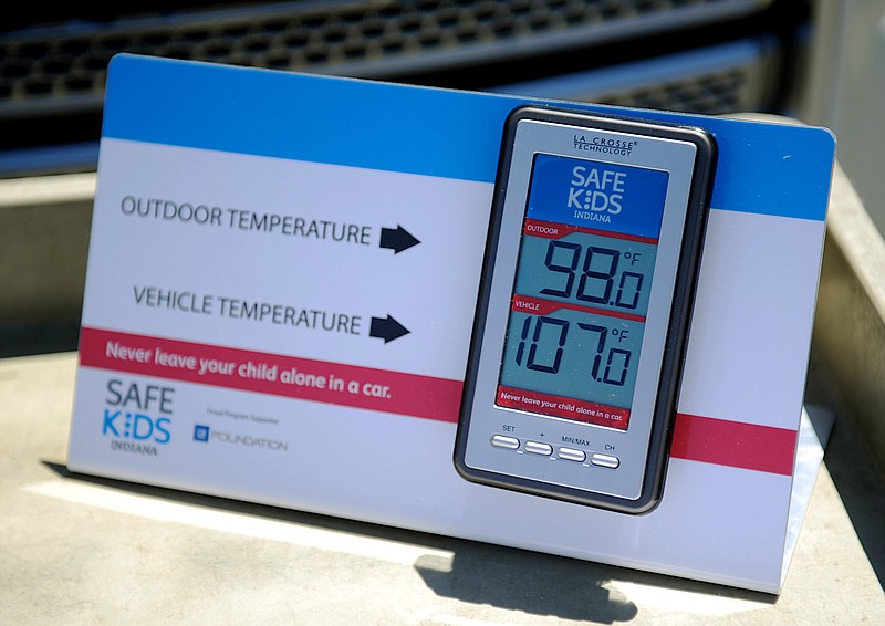 In this July 30, 2015, file photo, St. Mary's and Safe Kids Coalition uses a wireless monitor to record the temperature outside and inside of a closed vehicle at St. Mary's Market Days in Evansville, Ind. The deaths of four children in hot cars in recent days has brought the number of such deaths across the U.S. this year to at least 23, nearly matching the total for all of 2015 and prompting experts to plead for vigilance and warn parents that it can happen to anyone.