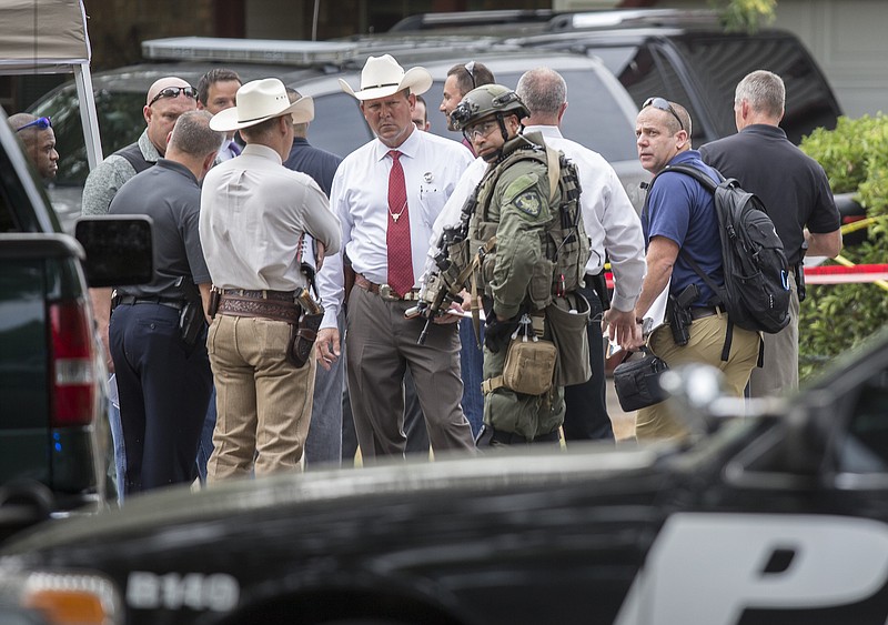 Law enforcement officers from multiple Central Texas agencies respond Monday, July 25, 2016, to reports of an officer down in Round Rock, Texas. Sgt. Craig Hutchinson with the Travis County Sheriff's Office was shot and killed at his home north of Austin before dawn on Monday in what authorities said appeared to be an attempted burglary. MIDDLE RIGHT: Sgt. Craig Hutchinson.
