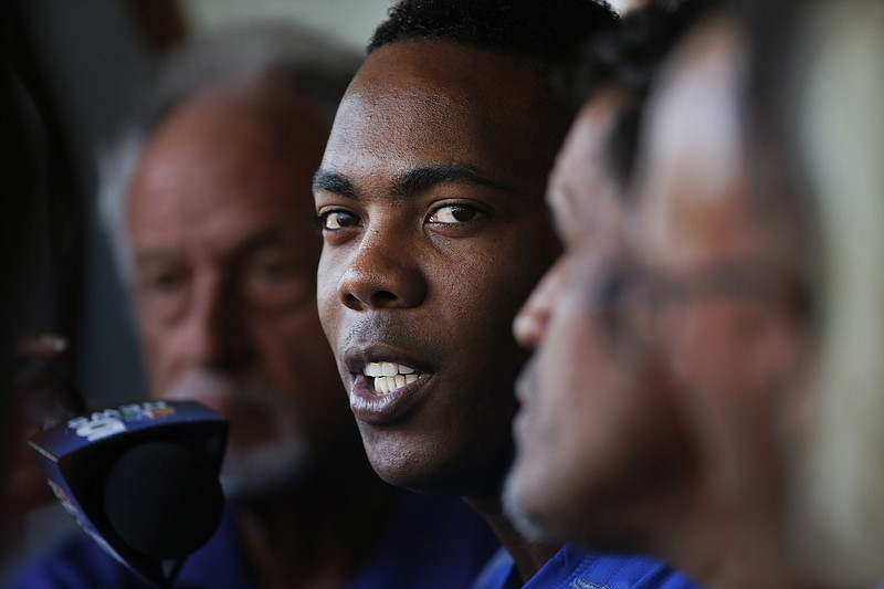 Chicago Cubs reliever Aroldis Chapman responds to a question as he meets reporters before a baseball game between the Chicago White Sox and Cubs Tuesday, July 26, 2016, in Chicago.