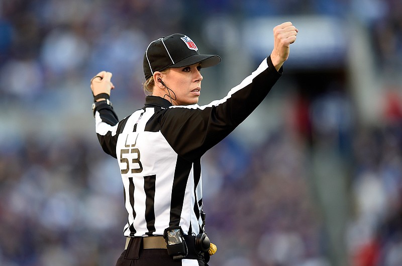 In this Nov. 15, 2015 file photo, NFL official Sarah Thomas signals in the second half of an NFL football game between the Baltimore Ravens and the Jacksonville Jaguars in Baltimore. Thomas, who was the first female to be a full-time game official in the NFL will again be the NFL's only female game official in 2016. 
