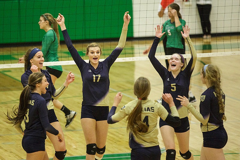 In this Oct. 20, 2015 file photo, Helias players celebrate a point scored during their Class 3 District 12 volleyball final match.