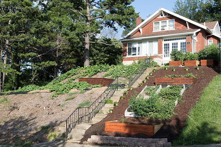 Kortney Gentner's home overlooking Rex Whitton Expressway in Jefferson City is surrounded by raised garden beds.