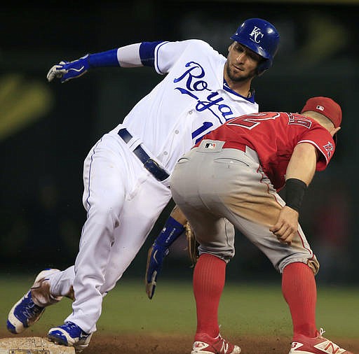 Kansas City Royals' Paulo Orlando (16) beats the tag of Los Angeles Angels second baseman Johnny Giavotella (12) during the fifth inning of a baseball game at Kauffman Stadium in Kansas City, Mo., Tuesday, July 26, 2016. Orlando was safe at second base with a stolen base on the play.