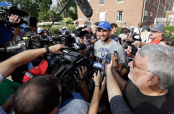 Colts quarterback Andrew Luck speaks with the media after arriving for training camp Tuesday in Anderson, Ind.