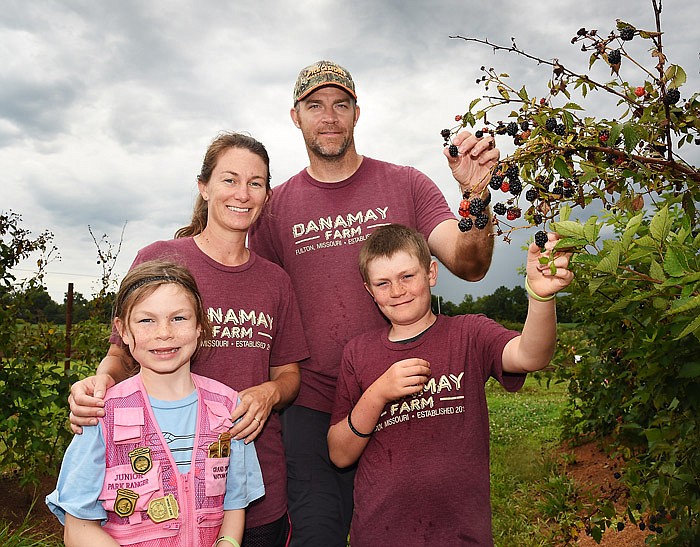 Amy and Gabe Craighead pose with their children, Isaiah, 10, and Alexandra, 7, Danamay Farm, just north of Fulton, Mo. They raise blackberries and blueberries, and the public can come in and pick their own and purchase them by the pound.