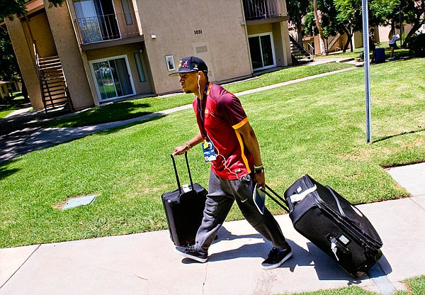 Rams rookie defensive back Jabriel Washington walks with his bags to his dorm room Tuesday on the campus of UC Irvine in Irvine, Calif., for training camp. 