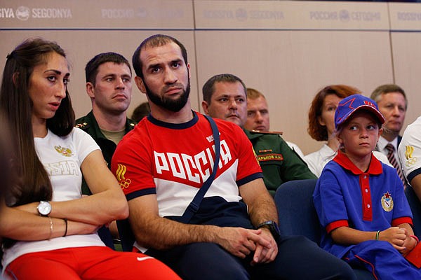 Russian triple jumper Yekaterina Koneva (left) and wrestler Islambek Albievas (center) take part in Tuesday's meeting marking the departure of Russian sportsmen of CSKA (Red Army) club to the Rio Olympics in Moscow, Russia.