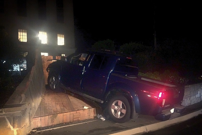 A man driving southbound on State Line Avenue early Tuesday morning, July 26, 2016 failed to turn right and crashed into the fountain behind the Downtown Post Office, Texarkana, Texas, police officers said. People playing Pokémon Go nearby said "it sounded like a train wreck" when the blue Nissan Frontier struck the brick fountain. The driver and a passenger were taken to a local hospital with unknown injuries, police said.
