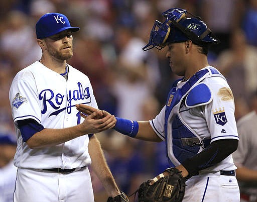 Kansas City Royals relief pitcher Wade Davis (17) is congratulated by catcher Salvador Perez, right, following a baseball game against the Los Angeles Angels at Kauffman Stadium in Kansas City, Mo., Wednesday, July 27, 2016. The Royals defeated the Angels 7-5. 