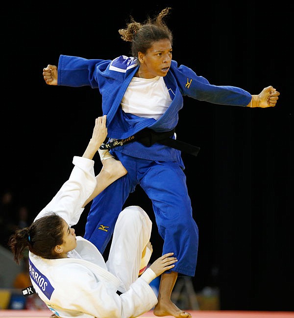 In this July 12, 2015, file photo, Rafaela Silva (top) of Brazil competes against Anriquelis Barrios of Venezuela during a women's 57kg bronze medal judo match at the Pan Am Games in Mississauga, Ontario.