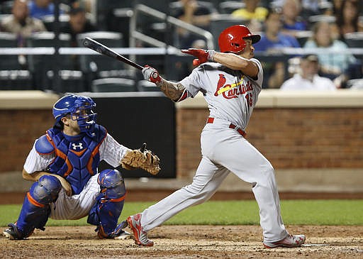 St. Louis Cardinals' Kolten Wong (16) hits an RBI double off New York Mets relief pitcher Jeurys Familia during the ninth inning of a baseball game, Wednesday, July 27, 2016, in New York. Mets catcher Travis d'Arnaud watches. The Cardinals won 5-4.