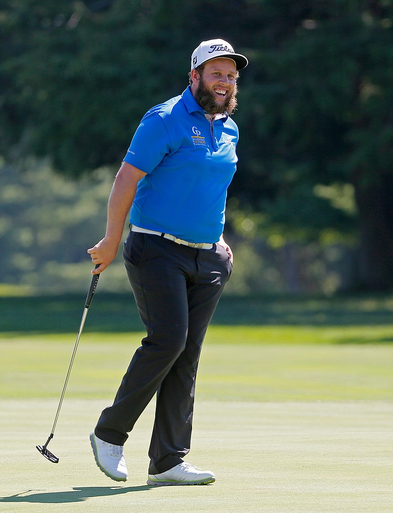 Andrew Johnston, of England, smiles after a putt on the 11th hole during a practice round for the PGA Championship golf tournament at Baltusrol Golf Club in Springfield, N.J., Tuesday, July 26, 2016. 