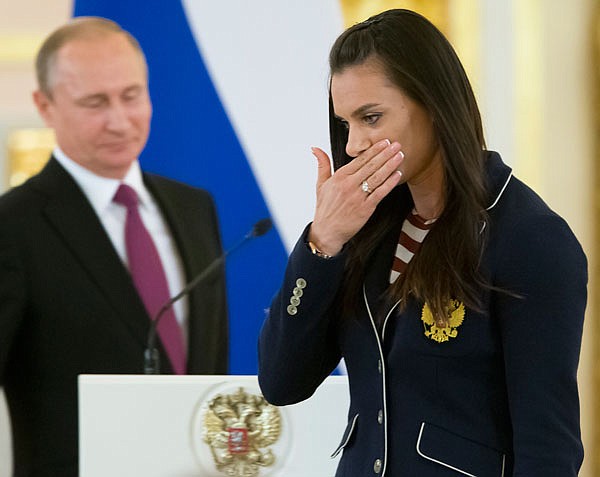 Russian pole vaulter and Olympic champion Yelena Isinbayeva gestures after speaking at the Kremlin on Wednesday during a reception for the Russia's Olympics team in Moscow.