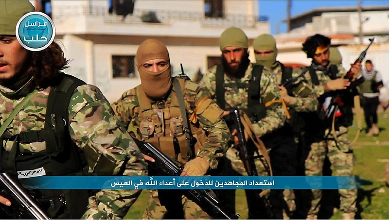 This file photo posted on the Twitter page of Syria's al-Qaida-linked Nusra Front on April 1, 2016, shows fighters from al-Qaida's branch in Syria, the Nusra Front, marching toward the northern village of al-Ais in Aleppo province, Syria. Al-Qaida's branch in Syria is considering splitting ties with the global terror group, but the Nusra Front's intention to make it more appealing to the West may in fact be a tactical move aimed at undermining ongoing talks between the U.S. and Russia on a military partnership in Syria. 