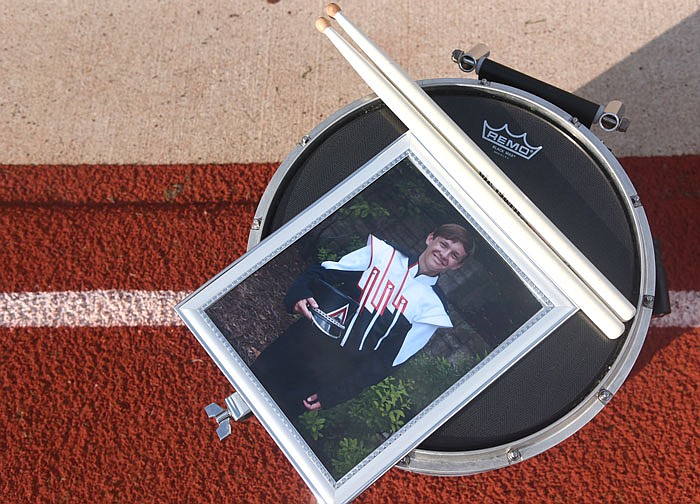 A framed photo of Caleb McClain sits on a drum snare at the Jefferson City High School band's annual ice cream social. McClain was killed in a car crash with his girlfriend earlier this summer, and the band members paid tribute to their deceased drumline member.