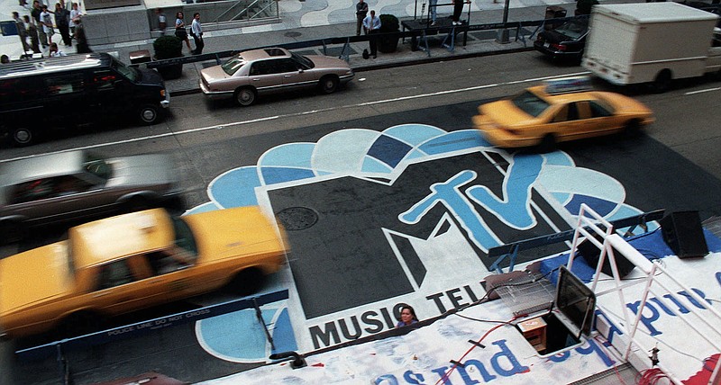 In this Sept. 3, 1996, file photo, traffic moves along 6th Avenue in New York, over the logo painted in the street outside Radio City Music Hall for the MTV Music Video Awards ceremony. MTV announced July 28, 2016, that it is rebranding VH1 Classic as MTV Classic and the channel will focus on 1990s and early 2000s nostalgia.