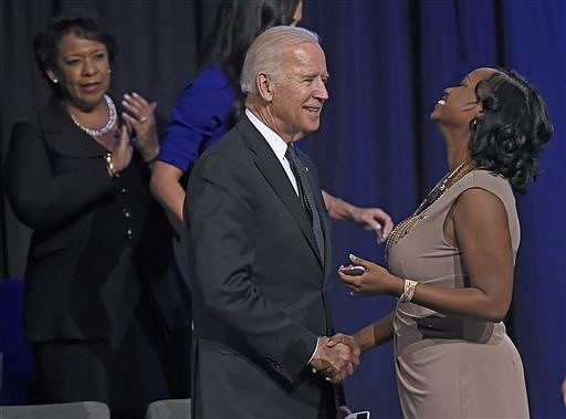 Attorney General Loretta Lynch, from left, watches Vice President Joe Biden greet Trenisha Jackson, wife of Corporal Montrell Jackson during a memorial service for three law enforcement officers at Healing Place Church in Baton Rouge, La., Thursday, July 28, 2016. The gunman's bullets that killed the officers in Baton Rouge also targeted the country and "touched the soul of an entire nation," Vice President Joe Biden said Thursday at the memorial service for the fallen officers. (Bill Feig/The Advocate via AP)

