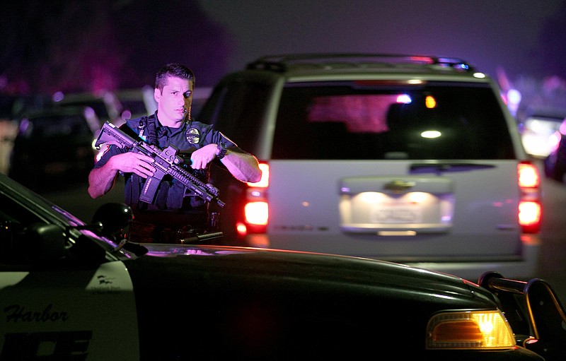 A San Diego Harbor Police officer helps to secure the scene  Thursday night, July 28, 2016, near the corner of 39th Street and Boston Avenue in San Diego near where two San Diego Police officers were shot.