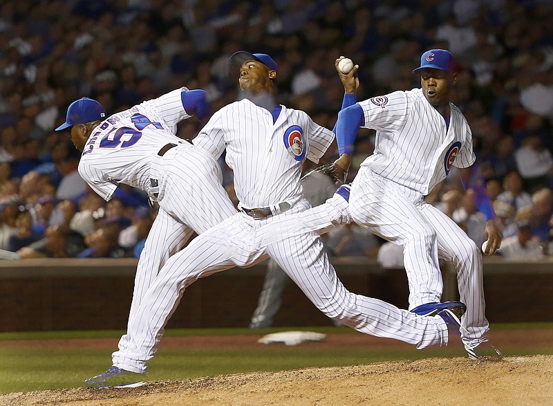 Chicago Cubs relief pitcher Aroldis Chapman delivers in this multiple exposure photo during the ninth inning of a baseball game against the Chicago White Sox Thursday, July 28, 2016, in Chicago. Chapman recorded his first save as a Cubs beat the Chicago White Sox 3-1.